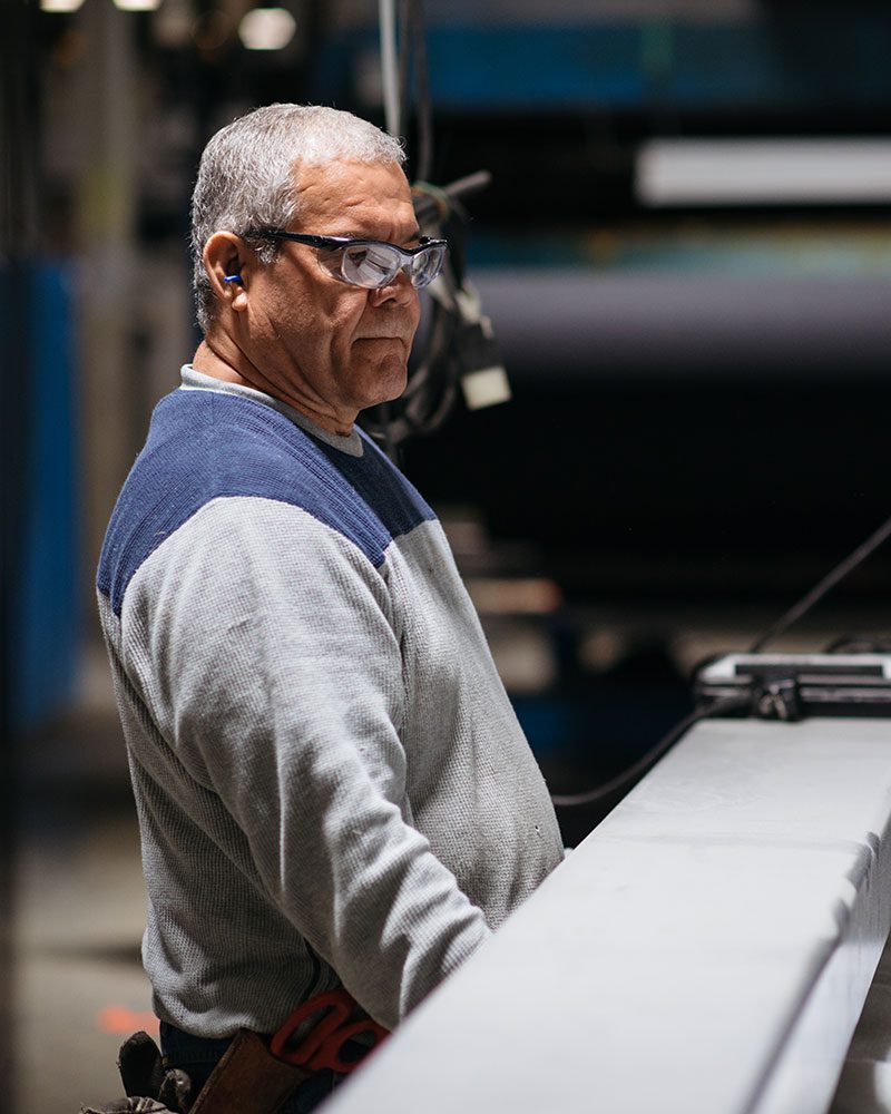 man controlling manufacturing machine