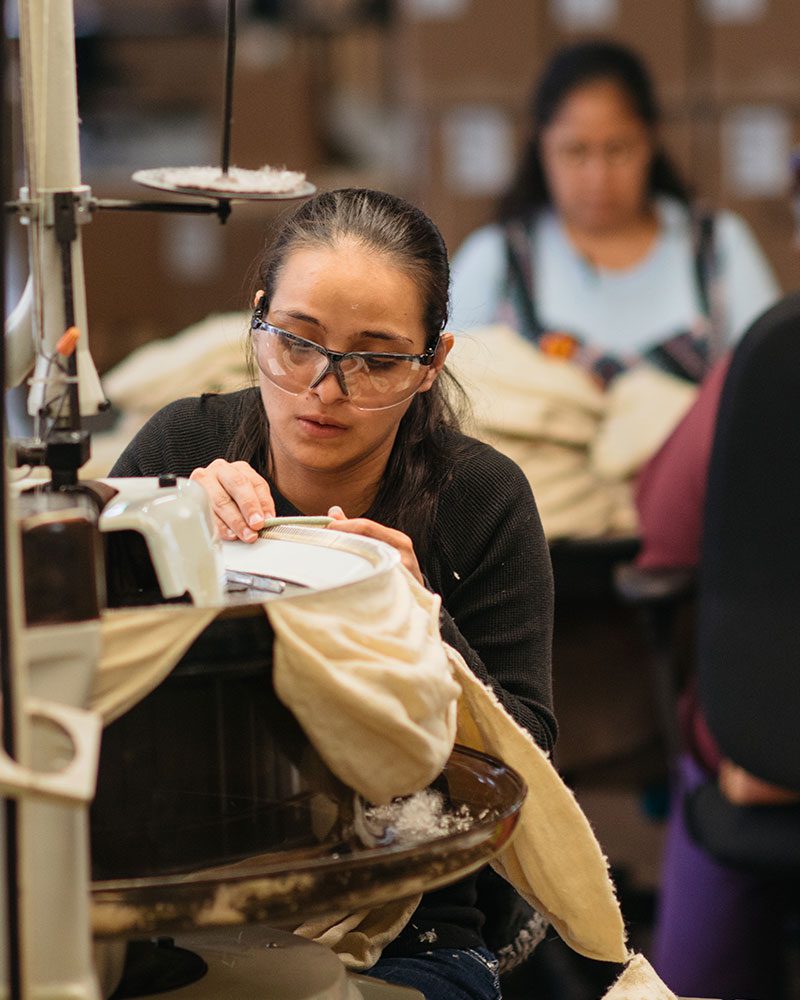 woman sewing berets